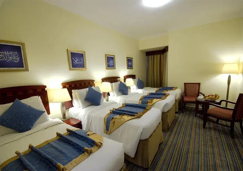 /media/umrah-images/room-with-4-single-beds-.webp
