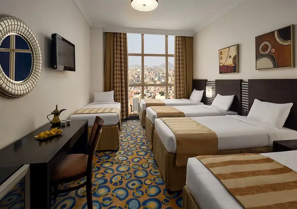 /media/umrah-images/room-with-5-single-beds-.webp